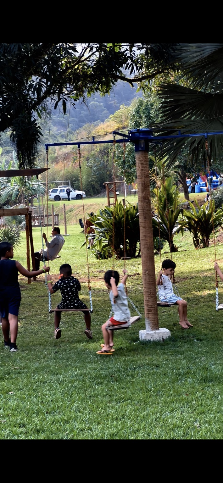 Crianças brincando nos balanços do Sítio
